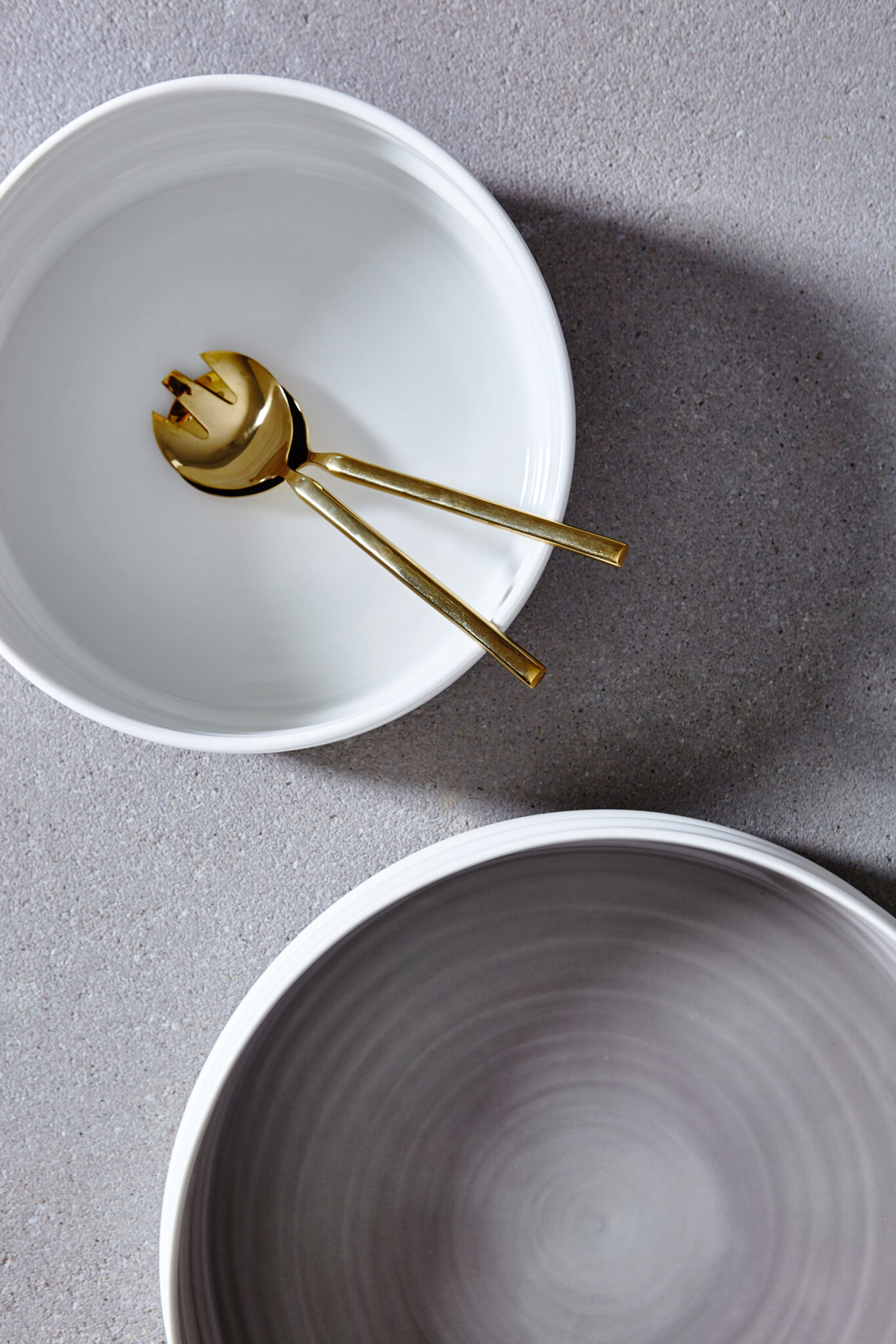 Keramikschalen von aestone ceramics mit goldenem Besteck in einer Draufsicht